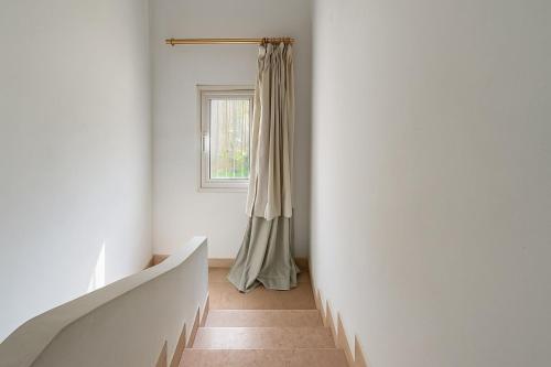 a hallway with a staircase and a window at 1038 · 2BR TownhouseBath TV Backyard in Sheikh Zayed