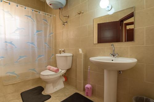 a bathroom with a toilet and a sink and a shower at 1038 · 2BR TownhouseBath TV Backyard in Sheikh Zayed