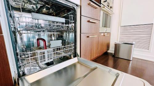 a dishwasher with dishes in it in a kitchen at Superior Lakeview Luxury 3-Bedroom Suite on High Floor in Toronto