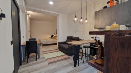 a kitchen and living room with a table and a couch at La Piccola Corte da Anita in Tortolì