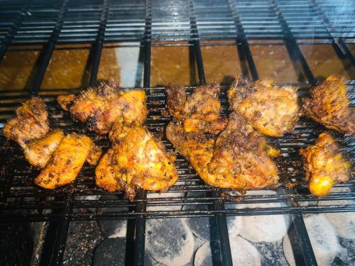 a bunch of chicken on a grill in an oven at Dhona's Villa in Sigiriya