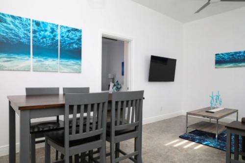 a dining room with a table and chairs and a tv at Ocean Breeze Resort in NCA