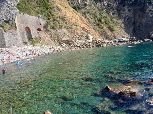 a group of people in the water at a beach at Locanda Ca Da Iride in Riomaggiore