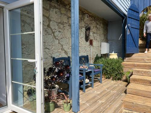 a patio with a table and chairs on a deck at Serendipity flat in Isle of Wight