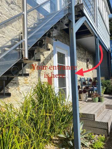 a house with a staircase with a red arrow pointing to your entrance at Serendipity flat in Isle of Wight