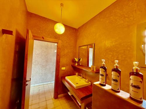 a bathroom with two bottles of alcohol on a counter at Kasbah Oum Rabia in Boulaouane