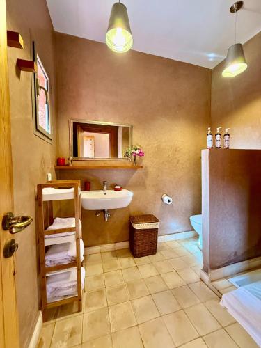 a bathroom with a sink and a toilet at Kasbah Oum Rabia in Boulaouane