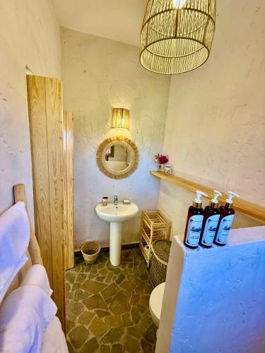 a bathroom with a sink and a toilet and a mirror at Kasbah Oum Rabia in Boulaouane