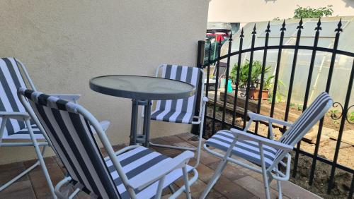 a table and four chairs and a table and a fence at Brne Family House in Postojna