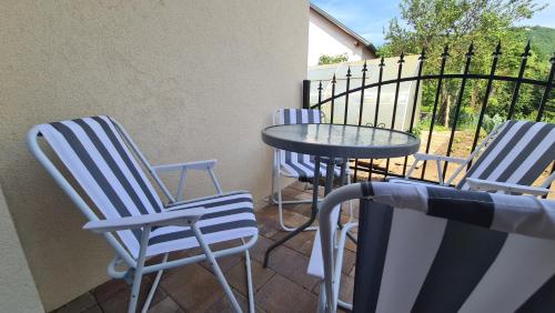 three blue chairs and a table on a patio at Brne Family House in Postojna