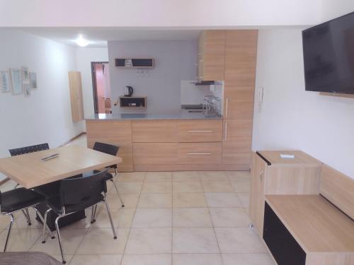 a kitchen with a table and a dining room at Premium Mendoza Apart Hotel in Mendoza