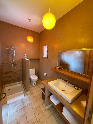 a bathroom with a sink and a shower and a toilet at Kasbah Oum Rabia in Boulaouane