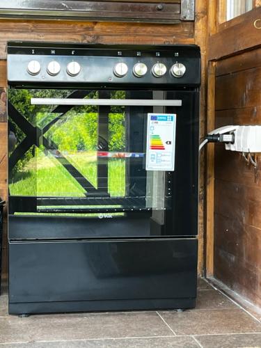 a black oven with a sign on the door at Apartmani Lunija in Gornji Milanovac