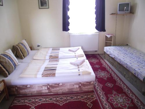 a bedroom with two beds and a window at Penzión Slávia in Poprad
