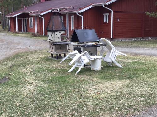 a group of chairs sitting around a table with a laptop at Koli country club basic in Hattusaari