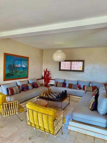a living room with a couch and a chess board at Kasbah Oum Rabia in Boulaouane