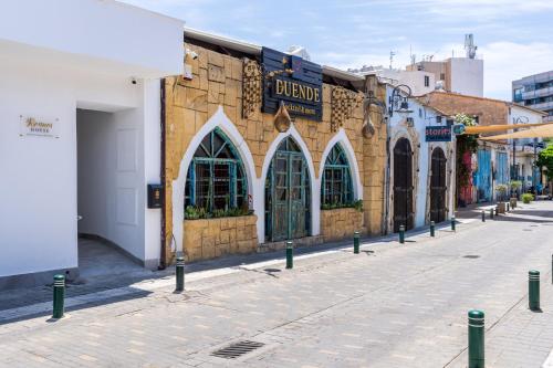 a street with a building with arched windows on it at Le Bandit Studio in Larnaka