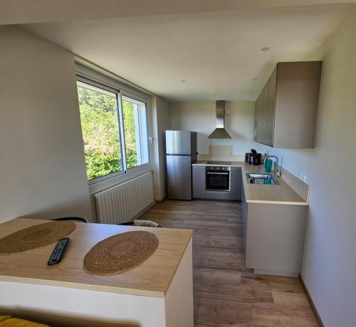 une cuisine avec une table et un comptoir dans l'établissement Chez Lili, à Roiffieux