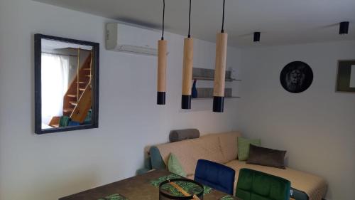a living room with a couch and a mirror at VALI in Baška