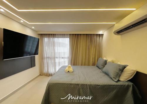 a bedroom with a bed with two stuffed animals on it at Vert House Jardim Oceania - Miramar Hospedagens in Tambaú