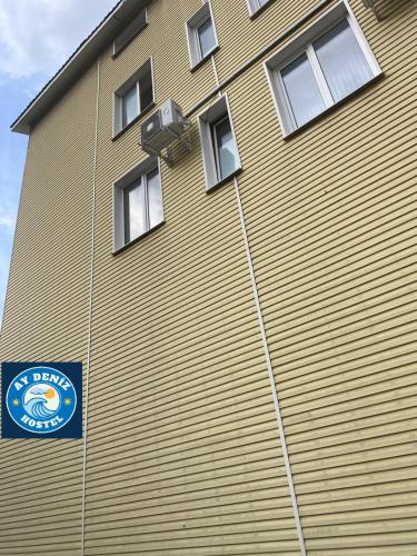 a building with a sign on the side of it at Aydeniz hostel in Chişinău