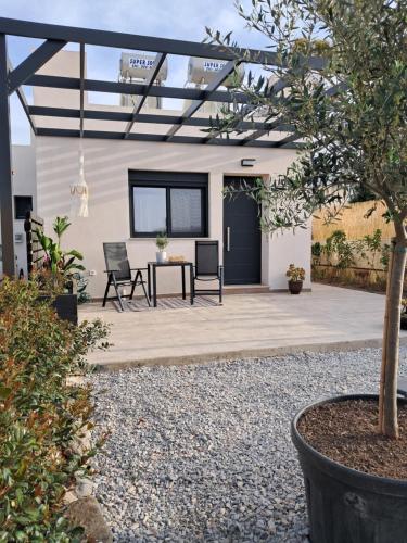 a patio with a table and chairs and a building at The Boho Breeze Studio in Kos Town