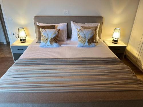 a bedroom with a large bed with two lamps at Sami Loft in Sami