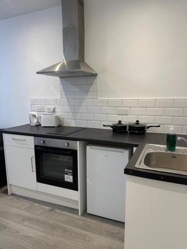 a kitchen with a sink and a counter top at Train Station Aparthotel - Free Wifi, Free Parking in Scunthorpe