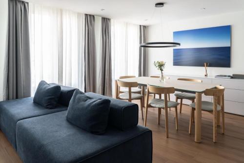 a living room with a couch and a table at Hotel Leev Victoire & Spa in Paris
