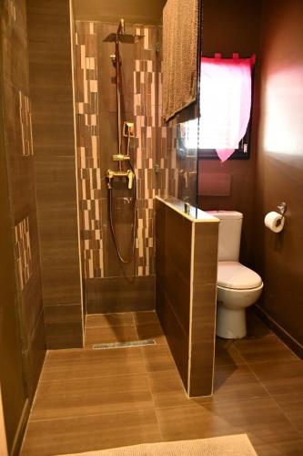 a bathroom with a shower with a toilet and a sink at Chacha house in Yasmine