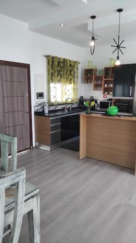 a large kitchen with a counter and a counter top at Chacha house in Yasmine