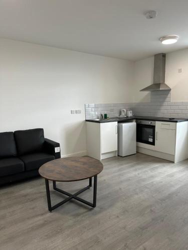 a living room with a couch and a coffee table at Train Station Aparthotel - Free Wifi, Free Parking in Scunthorpe
