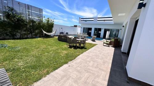 a backyard of a house with a table and chairs at Chacha house in Yasmine