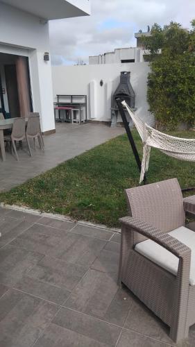 a patio with a bench and a table and chairs at Chacha house in Yasmine