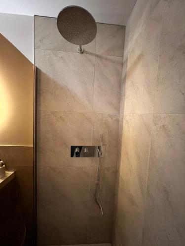 a bathroom with a shower with a shower head at Luxury Spa with Sauna, Bath and Cinema Private in Bodegraven