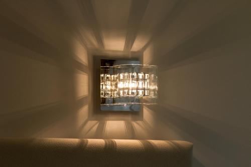 a light fixture on a wall in a room at Pellegrini Luxury Rooms in Split