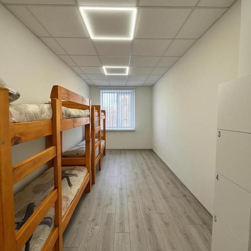 a room with bunk beds and a window at Aydeniz hostel in Chişinău