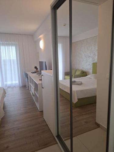a room with a bedroom with a bed and a mirror at My Blaxy apartment in Olimp
