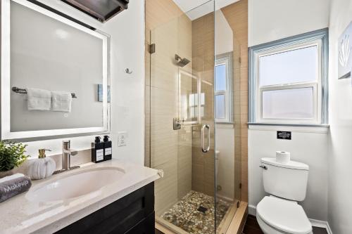 a bathroom with a sink and a toilet and a shower at Newly Remodeled Cozy Beach Retreat Ocean Views in Manhattan Beach