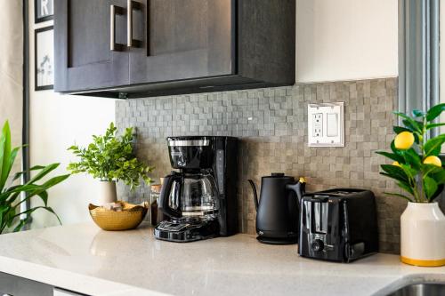 a kitchen counter with a coffee maker on it at Newly Remodeled Cozy Beach Retreat Ocean Views in Manhattan Beach
