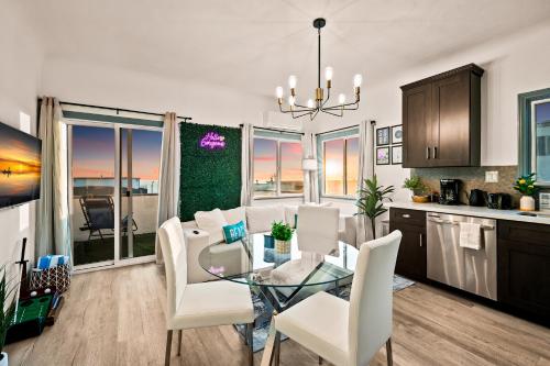 a kitchen and living room with a table and chairs at Newly Remodeled Cozy Beach Retreat Ocean Views in Manhattan Beach