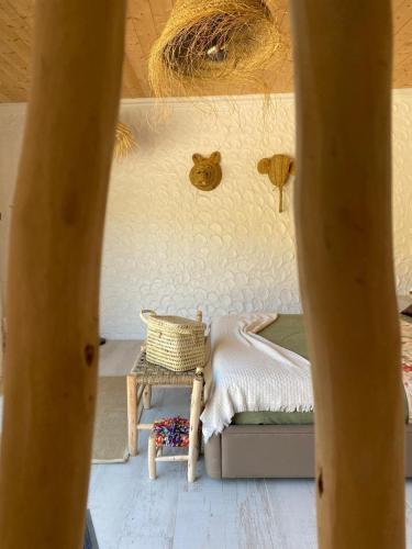 a small bedroom with a bed and a table at Portugals Infinity Eco Suite Resort in Tavira