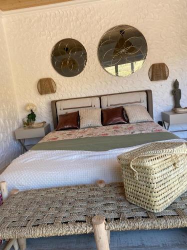 a bedroom with a large bed with two windows at Portugals Infinity Eco Suite Resort in Tavira