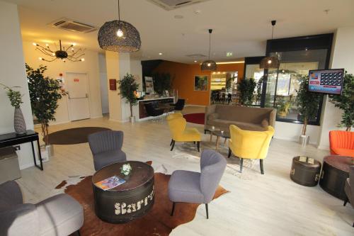 a lobby with chairs and a table in a store at Tempo Fair Suites in Istanbul