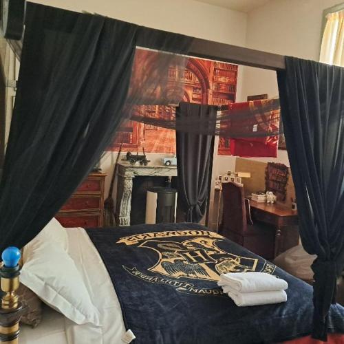 a bedroom with a bed with black curtains at GRAZZANO ANTICA STAZIONE in Grazzano Visconti