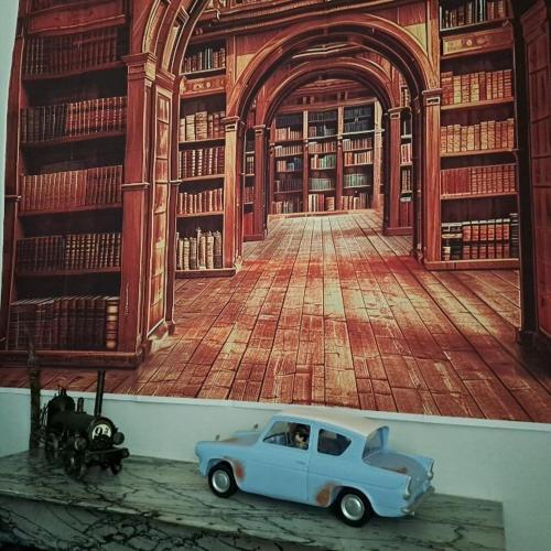 a picture of a library with a blue car in front at GRAZZANO ANTICA STAZIONE in Grazzano Visconti