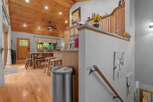 a kitchen and dining room with a wooden ceiling at Mins To Highlands Hot Tub, Fire Pit, Game Room in Franklin