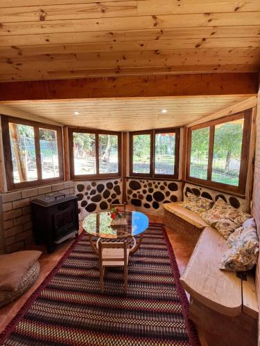 a living room with a couch and a fireplace in a cabin at Associação Quinta das Relvas in Branca