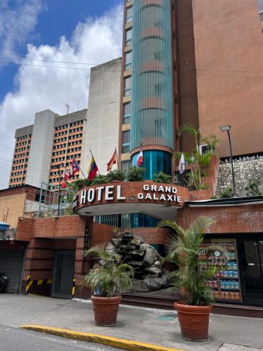 a hotel sign on the side of a building at Hotel Grand Galaxie in Caracas