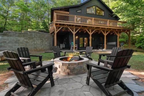 a patio with chairs and a fire pit in front of a house at Mins To Highlands Hot Tub, Fire Pit, Game Room in Franklin